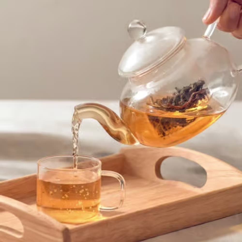 Pouring tea from a glass teapot